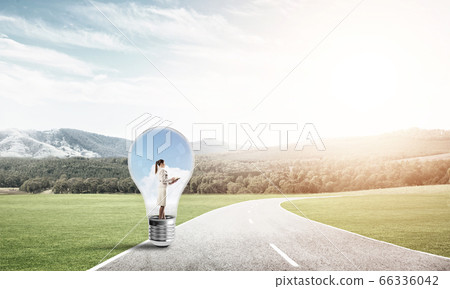 Businesswoman inside light bulb Businesswoman inside light bulb 66336042