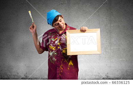 Young handsome painter artist holding paintbrush Young handsome painter artist holding paintbrush 66336125