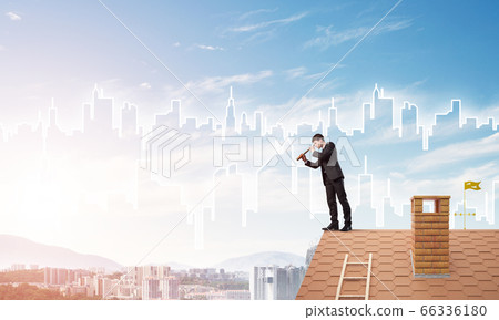 Engineer man standing on roof and looking in spyglass. Mixed media Engineer man standing on roof and looking in spyglass. Mixed media 66336180