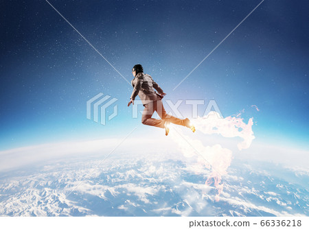 Businessman in suit and aviator hat flying in sky 66336218