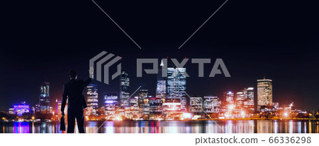Businessman viewing night glowing city 66336298