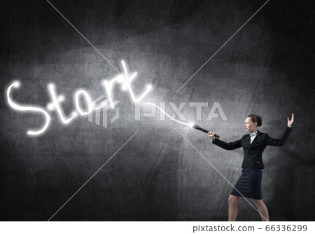 Woman with flashlight in hand 66336299