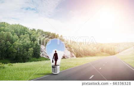 Businesswoman inside light bulb 66336328