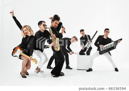 Entertaining concept, teamwork. International group of musicians on a white background, guitarist, drummer, soloists, saxophonist. 66336594