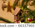 A wooden house shaped Christmas Tree Decoration hanging from a tree 66337960
