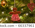 A fabric gingerbread man woman bear shaped Christmas Tree Decoration hanging from a tree 66337961