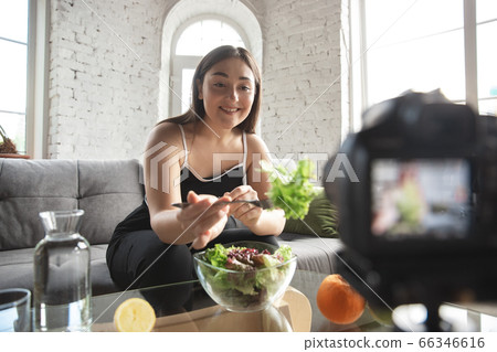 Caucasian blogger woman make vlog how to diet and lost weight. Lifestyle, influencer women, healthy concept. Caucasian blogger woman make vlog how to diet and lost weight. Lifestyle, influencer women, healthy concept. 66346616