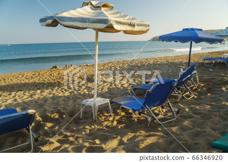 Scenic view of sandy beach with sun beds from the sea. 66346920
