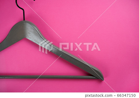 Empty gray clothes hanger on bright pink background. Flat lay, top view, copy space 66347150