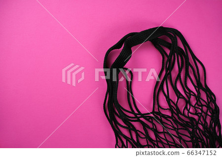 Black string eco shopping bag on pink background. Market, ecology concept. Top view, flat lay, copy space Black string eco shopping bag on pink background. Market, ecology concept. Top view, flat lay, copy space 66347152