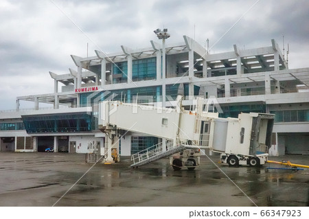 Taken from inside a small aircraft Boarding bridge protruding from the terminal building 66347923