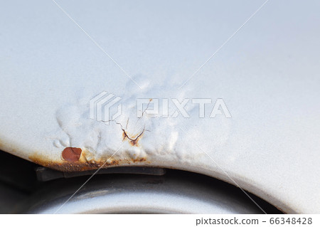Corrosion and rust on the hood of a car. The concept of anti-corrosion treatment of the car body, macro Corrosion and rust on the hood of a car. The concept of anti-corrosion treatment of the car body, macro 66348428