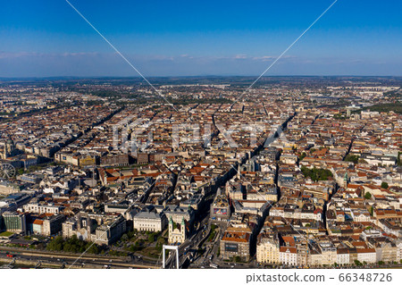 Beautiful view from the top of the city of Budapest, Hungary. Shot on a drone. Roofs and central streets are visible. Beautiful view from the top of the city of Budapest, Hungary. Shot on a drone. Roofs and central streets are visible. 66348726