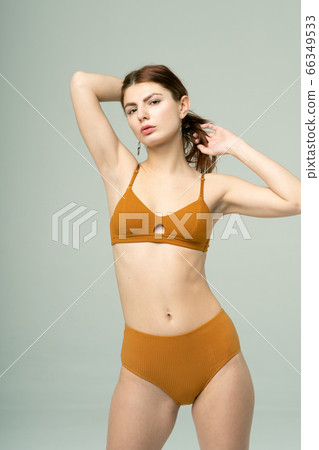 young beautiful girl pose in brown underwear in studio young beautiful girl pose in brown underwear in studio 66349533