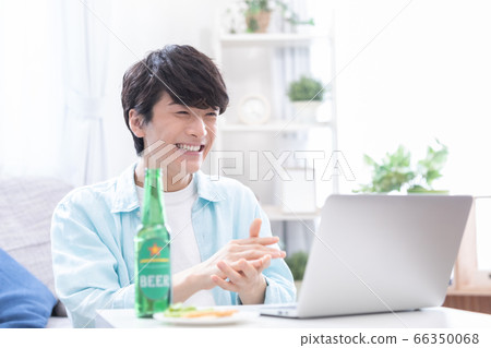 Young men attending an online drinking party with a laptop 66350068
