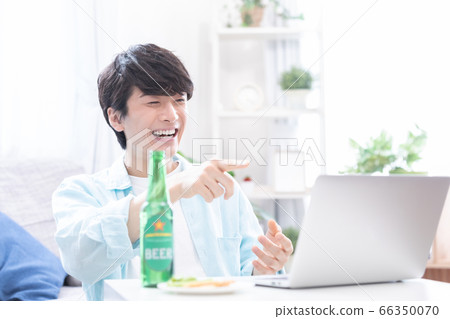 參加與膝上型計算機的網上喝酒的年輕人 66350070