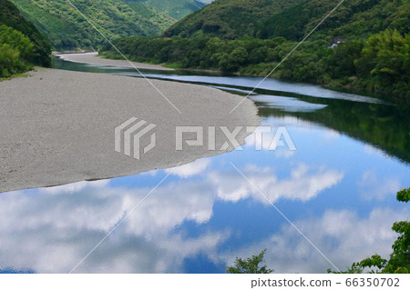 The Shimanto River flowing through the mountains. Kochi, Japan. Early June. The Shimanto River flowing through the mountains. Kochi, Japan. Early June. 66350702
