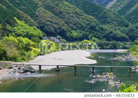 The Shimanto River and the Nakahanke settlement bridge flowing through the mountainous area. Kochi, Japan. Early June. 66350833