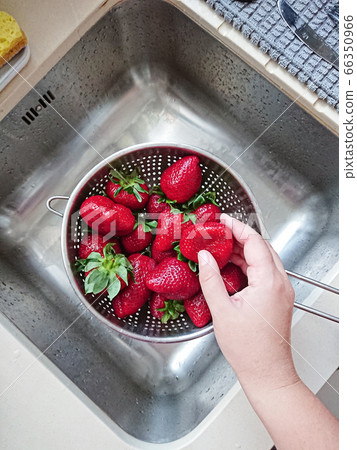 Washed ripe juicy red strawberries in mesh 66350966