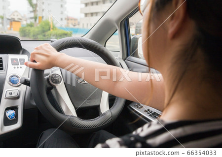 Young woman driving a car Young woman driving a car 66354033