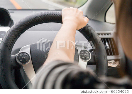 Young woman driving a car 66354035