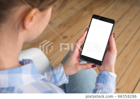 Mockup image - woman holding black smartphone with white blank screen Mockup image - woman holding black smartphone with white blank screen 66358286