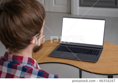 Man looking at laptop with white empty display Man looking at laptop with white empty display 66358287