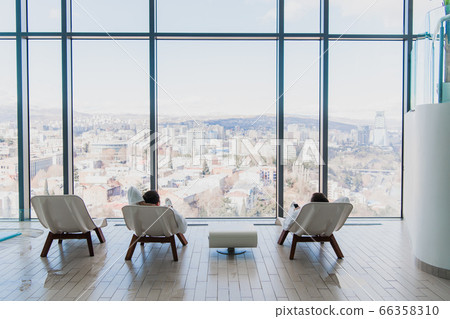 The man is relaxing after a spa. The guy after the massage. A man is resting in a massage after a bath. A man Lies on a lounger in an indoor pool. The man is sleeping after work. The man is relaxing after a spa. The guy after the massage. A man is resting in a massage after a bath. A man Lies on a lounger in an indoor pool. The man is sleeping after work. 66358310