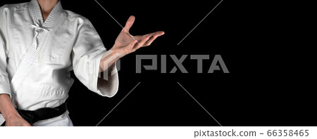 A person practicing aikido on a black background. 66358465