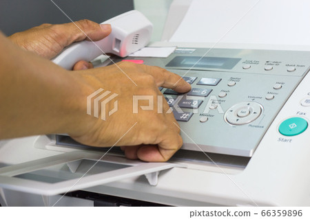 Men are using a fax machine in the office. business concept  66359896