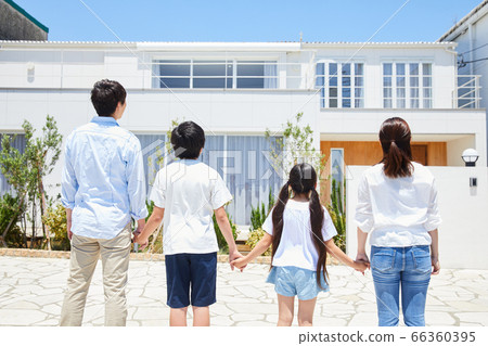 Family standing in front of my home under the blue sky 66360395