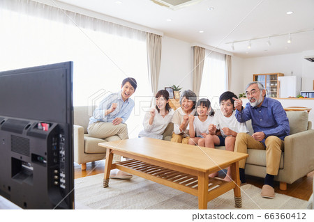 3 generation family living dining sitting on the sofa watching TV 3 generation family living dining sitting on the sofa watching TV 66360412