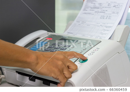 hand man are using a fax machine in the office Business concept hand man are using a fax machine in the office Business concept 66360459