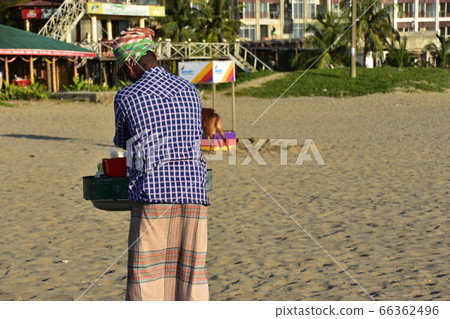 A Cox's Bazar beach resort in Bangladesh A man selling homemade snacks on the beach 66362496