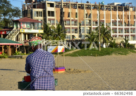 Cox's Bazar beach in Bangladesh A resort hotel under construction Men selling handmade snacks on the sandy beach 66362498