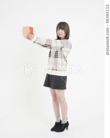 A woman giving a gift A woman giving a gift 66365113