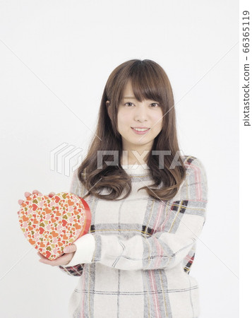 A woman giving a gift 66365119