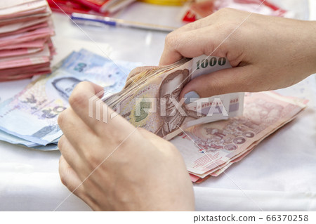 Hands counting of Thai baht notes money Hands counting of Thai baht notes money 66370258