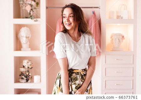 Happy young woman dressing up. Dressing room in pink Happy young woman dressing up. Dressing room in pink 66373761