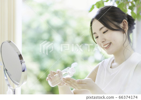 Young woman taking care of the skin in the living room Young woman taking care of the skin in the living room 66374174
