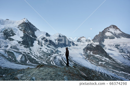 Tourist enjoying mountains scenery. Tourist enjoying mountains scenery. 66374298