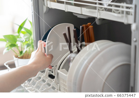 Woman putting dishes in the dishwasher 66375447