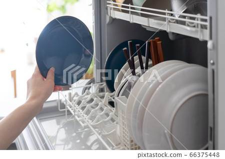 Woman putting dishes in the dishwasher 66375448