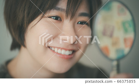 Woman in her 30s practicing smiling Woman in her 30s practicing smiling 66375855