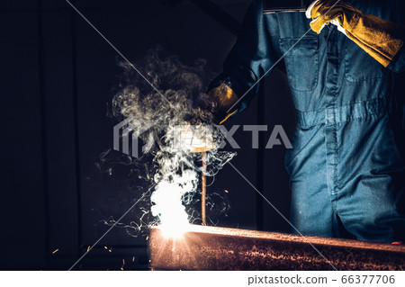 Metal welder working with arc welding machine. Metal welder working with arc welding machine. 66377706