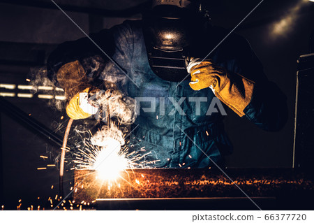 Metal welder working with arc welding machine. 66377720