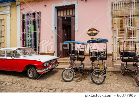 Cuban Trinidad street with colorful streetscape and classic car bicycle taxi Cuban Trinidad street with colorful streetscape and classic car bicycle taxi 66377909