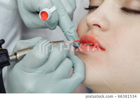 Woman having permanent makeup on lips Woman having permanent makeup on lips 66381534