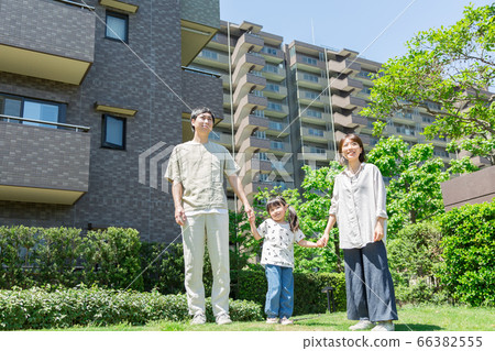 Parents and children holding hands and taking a walk outdoors (new lifestyle image) 66382555