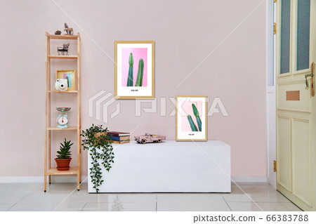 Pink wall, table, picture frame 66383788